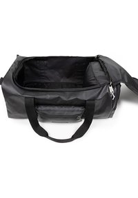 Musta kangaskassi, jossa on sileä pinta. Kassi on varustettu kaksoiskahvoilla ja vetoketjulla, joka avaa tilavan, tumman sisätilan.