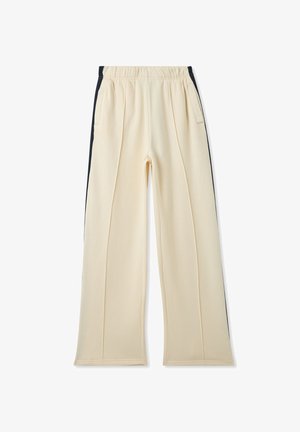 Pantaloni color crema con una texture morbida, dotati di tasche laterali e dettagli neri lungo le cuciture esterne. Vita elastica per il massimo comfort.