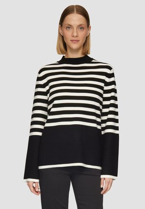 Black and white striped sweater with a high neckline and long, bell sleeves. Soft, textured knit fabric with a relaxed fit.