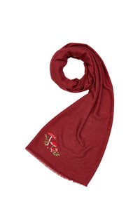 Écharpe rouge en tissu doux, ornée d'un bord à franges et d'un motif de champignon brodé avec des accents crème, rouge et vert.