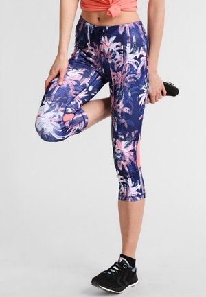 Tropical-patterned capri leggings in navy with pink and white palm leaves. Features mesh panel accents and a fitted design.