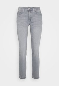 Svetle šedé džíny rovného střihu vyrobené z denimu. Mají přední kapsy, zapínání na zip s knoflíkem a klasický design s pěti kapsami.