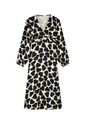 Zwarte hartpatronen op een crèmekleurige achtergrond, lange mouwen, een diepe V-hals en plooien bij de buste creëren een vloeiende, ontspannen silhouet.