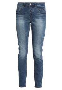 Chude dżinsy w wyblakłym niebieskim odcieniu, z przednimi kieszeniami, pojedynczym zapięciem na guzik oraz lekkim przetarciem dla dodatkowej faktury.