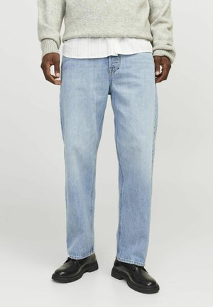 Light blue denim jeans with a straight-leg design, featuring visible stitching and a relaxed fit, paired with black chunky shoes.
