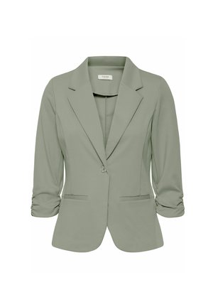 Blazer verde claro con un diseño entallado, cuello de muesca, cierre de un botón, mangas enrolladas y dos bolsillos frontales. Textura de tela suave.