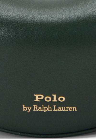 Caz de piele de un verde închis cu o textură netedă și litere aurii. Numele mărcii "Polo" deasupra "by Ralph Lauren" tipărit în mod proeminent.