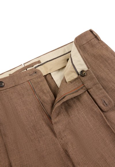 Brown houndstooth patterned trousers with open zipper fly, button closure, and beige inner waistband lining.