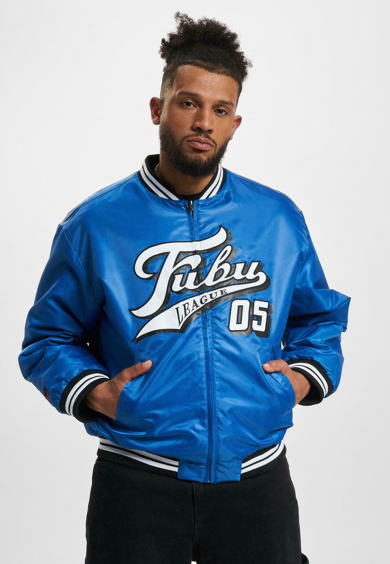 Blue satin bomber jacket with white and black accents. Features large front logo, ribbed collar, and elastic cuffs.