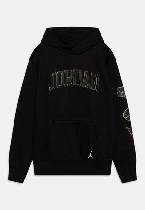 Czarna bluza z kapturem z napisem "JORDAN" na piersi, złoconymi grafikami na prawym rękawie i złotym logo Jumpman w pobliżu przedniej kieszeni.