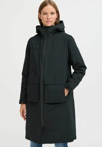Black waterproof parka with a zip closure, adjustable hood, and two large front pockets, featuring a smooth texture and casual design.