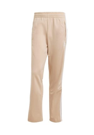 Pantaloni sportivi beige con una texture liscia, fascia elastica in vita, tasche laterali e strisce laterali bianche. Presenta un dettagli del logo sul davanti.