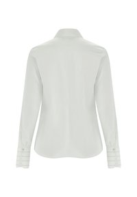 Camicia bianca a maniche lunghe con colletto. Tessuto liscio, orlo curvo e polsini con bottoni caratterizzati da righe orizzontali.