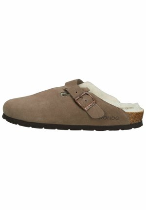 Brown suede slip-on shoe with a soft white lining, adjustable buckle strap, and a cork footbed. Features a textured black rubber sole.