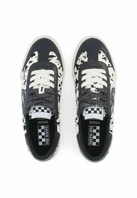 Black and white sneakers with a speckled pattern, featuring grey laces, a rubber sole, and checkered interior branding.