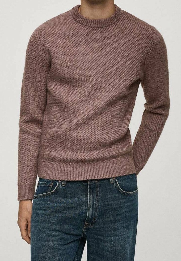 Brauner Pullover aus strukturiertem Strick mit Rundhalsausschnitt und gerippten Bündchen, kombiniert mit dunkler Jeans. Schlichtes, figurbetontes Design.
