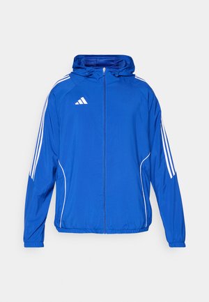 Blue lightweight jacket with a zip front, hood, elastic cuffs, and white stripes along the sides. Features a logo on the upper left chest.