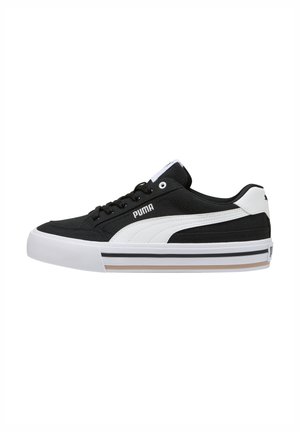 Sneaker bianco e nero con tomaia in tela testurizzata, design con lacci, collo imbottito e suola in gomma con accenti a strisce.