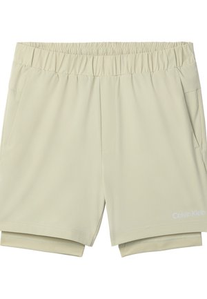 Beżowe szorty z elastycznym pasem, wewnętrzną warstwą kompresyjną, bocznymi kieszeniami i logo Calvin Klein na dolnej części prawej nogawki.