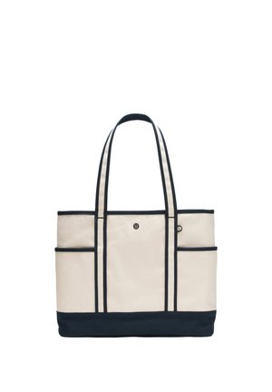 Beige canvas draagtas met zwarte bies, zwarte bodem, twee lange hengsels en klein logo aan de voorkant in het midden.