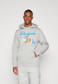 Gray hoodie featuring a blue "Dodgers" graphic, a championship ring illustration, and a front pocket. Soft, cotton material.