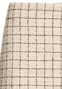 Tessuto a trama beige con un motivo a griglia e sottili linee nere. La texture è leggermente ruvida, evidenziando il design strutturato.