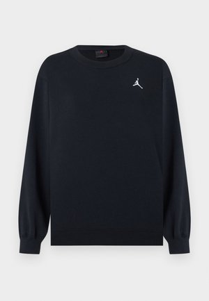 Črna majica z dolgimi rokavi in okroglim ovratnikom, z rebrastimi manšetami in spodnjim robom, z majhnim belim logotipom Jumpman na levi strani prsnega koša.