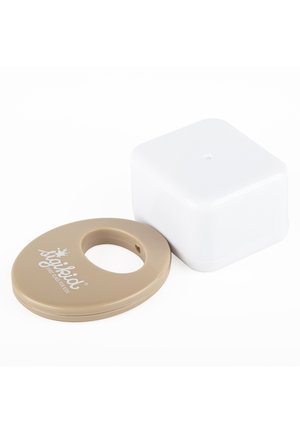 Beige teething ring with "spoiled first class for kids" text next to a white square silicone block on white background.