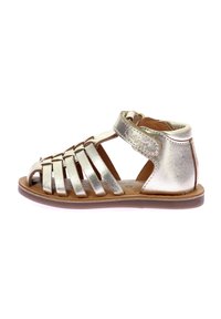 Sandalia de cuero dorado metálico con punta abierta y correas entrelazadas. Cuenta con una correa ajustable en el tobillo, suela plana y plantilla texturizada.