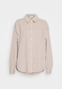 Camicia in corduroy beige con chiusura a bottoni sul davanti, maniche lunghe e colletto. Texture a coste verticali e dettaglio dell'orlo curvo.