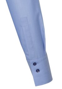 Light blue dress shirt sleeve featuring a smooth texture, a tailored cuff, and two dark buttons for closure.