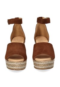 Brown suede platform sandals with an open toe, ankle strap, and jute-wrapped wedge heel featuring white accent stitching.