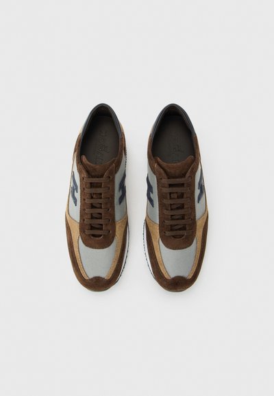 Pair of brown and beige suede sneakers with gray mesh panels and dark blue logo on sides, laced and viewed from above on white background.