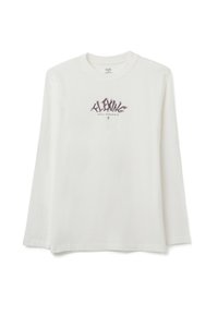 Maglietta bianca a maniche lunghe con scollo rotondo e stampa grafica con la scritta "FLEXING REAL STRUGGLE" in caratteri viola stilizzati.