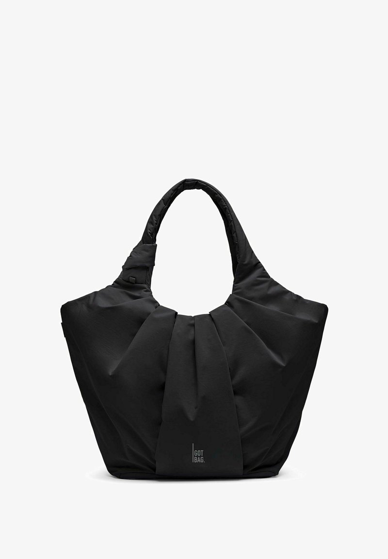 Sac cabas en tissu noir doux avec larges plis et poignées rembourrées, logo "Got Bag" au centre devant.