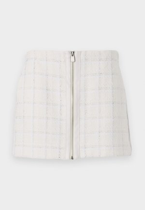Gonna mini bianca con texture, a motivo a quadri e accenti blu, dotata di chiusura con zip frontale. Il tessuto sembra morbido e leggermente strutturato.