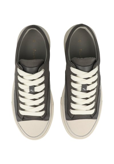 Pair of gray and beige low-top sneakers with white laces, viewed from above on a white background.