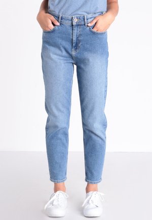 Light blue denim jeans with a high waist, tapered leg, five-pocket design, and subtle fading. Paired with white sneakers.
