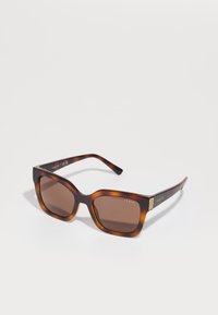 Ochelari de soare tortoise maro cu rame pătrate, lentile maro și detalii subtile cu logo pe brate; design elegant și finisaj lucios.