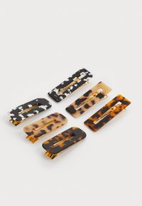 Set of six hair clips in muted colors, featuring black and white marbled, tortoiseshell, and clear designs with gold-tone hardware.