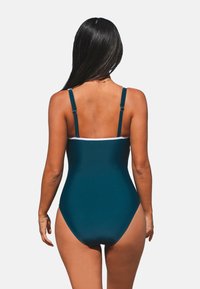 Blauwe eendelige zwempak met verstelbare straps en een witte accent aan de bovenkant, met een gladde textuur en hoge beenopeningen.