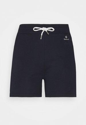 Navy blue shorts made of soft fabric, featuring a white drawstring with metal tips, and a small logo embroidered on the side.