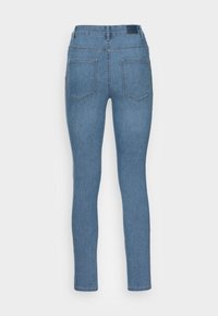 Vékony farmernadrág világoskék denim színben. Öt zsebbel, varrott részletekkel és márkás derékkal rendelkezik. Simára kidolgozott textúra, testhezálló fazon.
