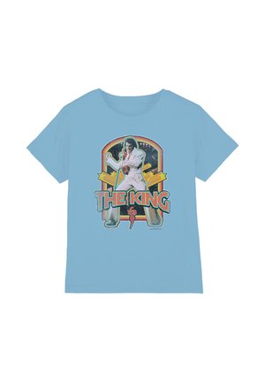 Light blue T-shirt featuring a performer in a white jumpsuit holding a microphone with "THE KING" text and starburst background.