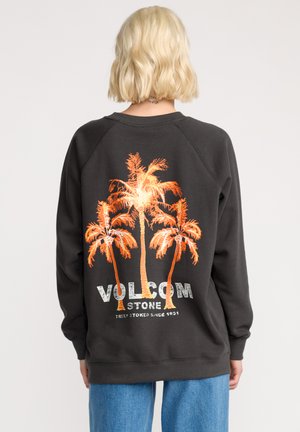 Felpa grigia scura con grafica di palma arancione e testo "VOLCOM" sul retro. Caratterizzata da maniche raglan e polsini a costine.