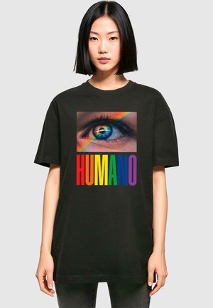Sort bomulds T-shirt med et trykt billede af et øje med regnbue detaljer over ordet "HUMANO" i fede, multikolore bogstaver.