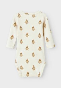 Långärmad baby bodysuit i krämfärg med ribbad textur, med ett upprepande mönster av bruna och orange svampar.