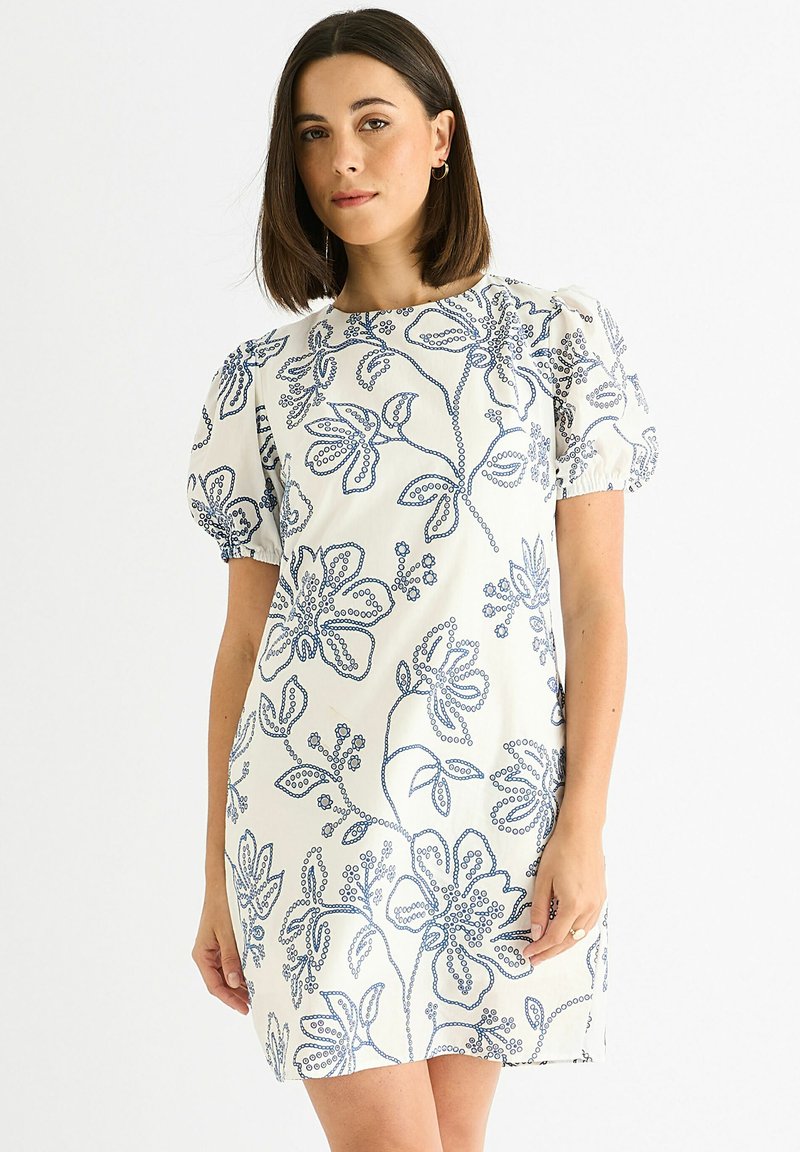 Short white dress with blue floral embroidery, puff sleeves, and a straight cut. Features a round neckline and soft texture.