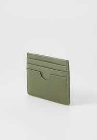 Green leather cardholder with a textured surface, featuring four slots for cards and a central cut-out for easy access.