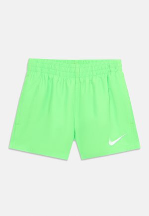Erksavrohelised spordipüksid elastse vöökohaga ja valge Nike swoosh-logoga vasaku alumise jala peal valgel taustal.